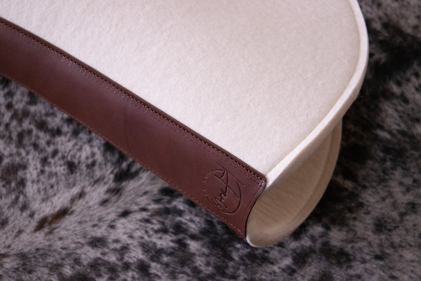 Leather feature, contoured spine, shaped fender pad - 13mm or 18mm felt in choc, grey or cream
